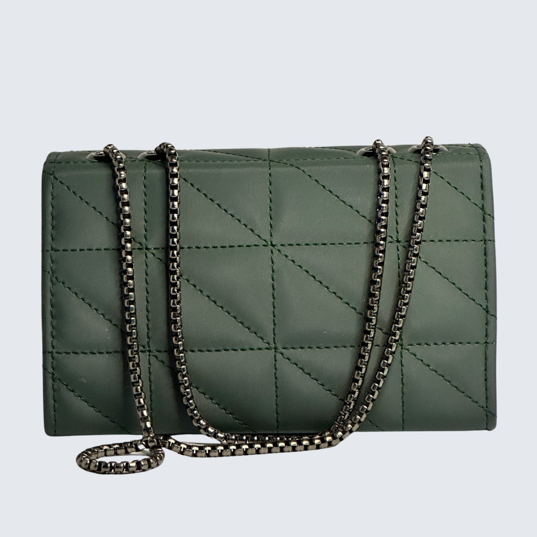 Green quilted handbag with a chain strap on a light gray background
