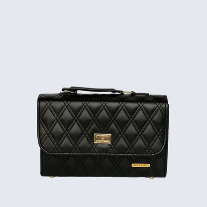 Black quilted handbag with gold accents on a light gray background