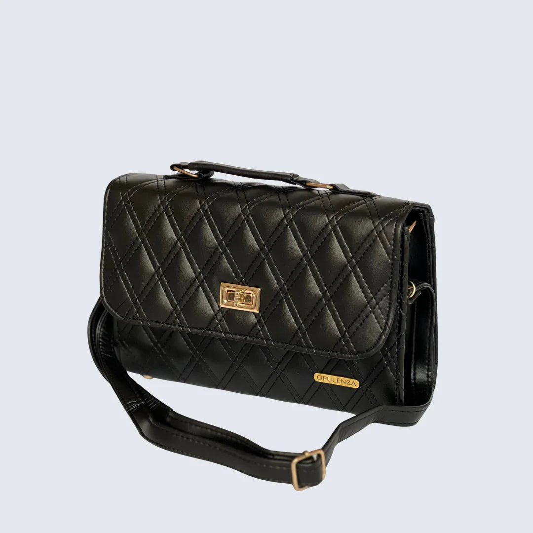 Black quilted handbag with gold accents on a light gray background