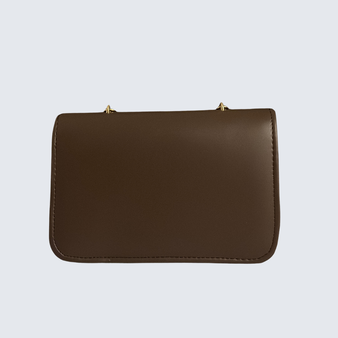 Brown leather handbag on a light gray background